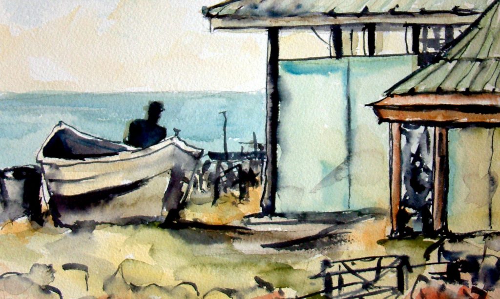 Silhouette of man by a boat with Caribbean water